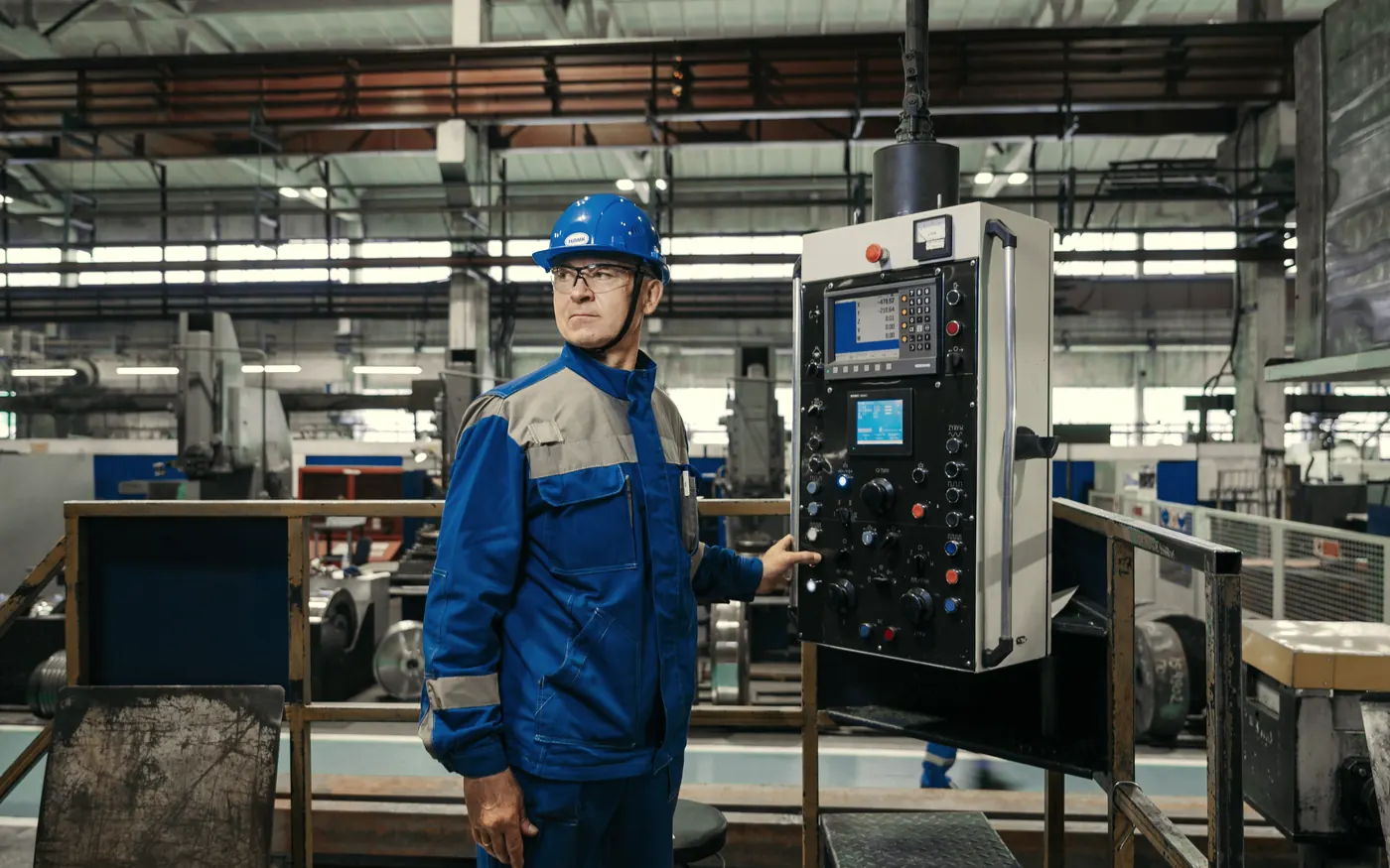 Operator at the control panel of a production line