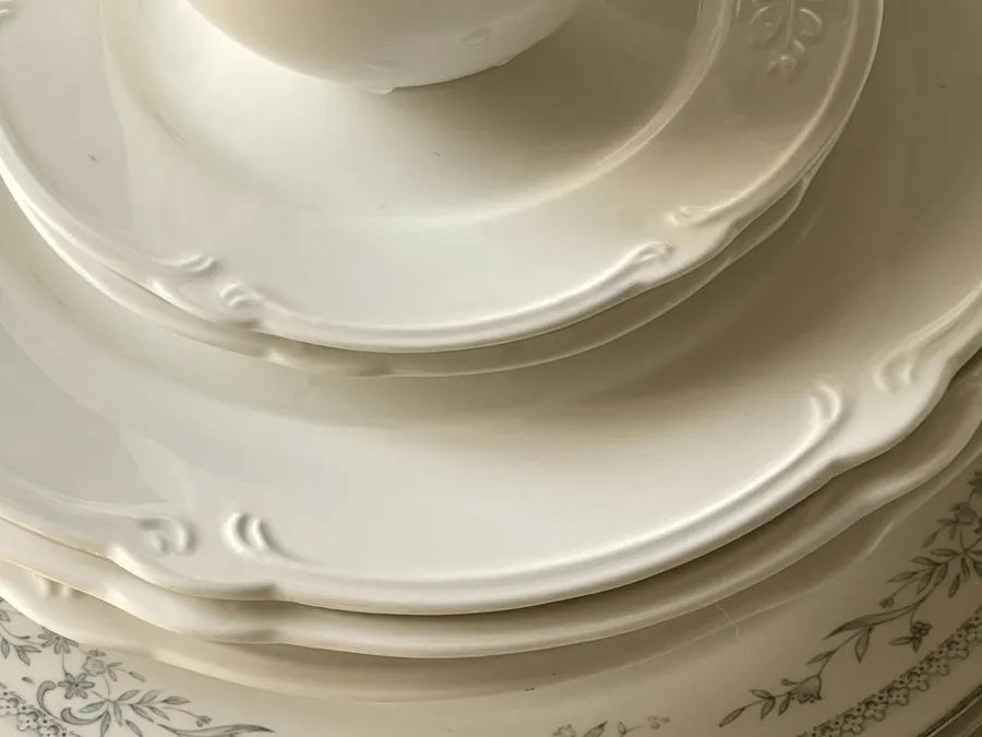 White porcelain plates and cup with embossed decoration